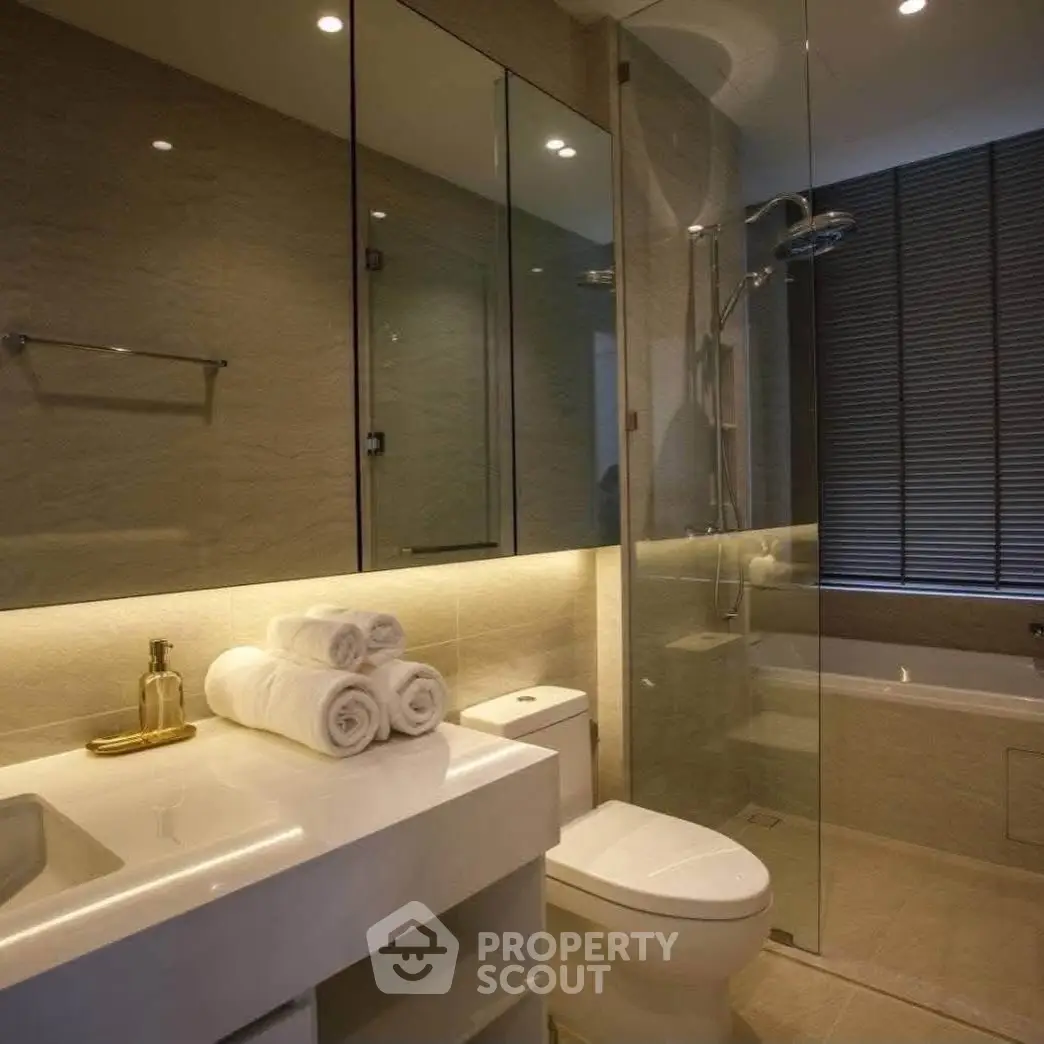 Luxurious modern bathroom with glass shower and elegant lighting