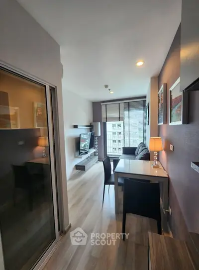 Modern living room with sleek design and city view, featuring stylish furniture and ambient lighting.