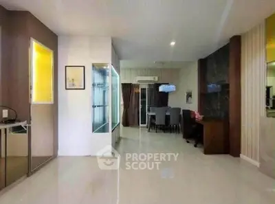 Spacious modern living area with sleek design and dining space, perfect for entertaining.