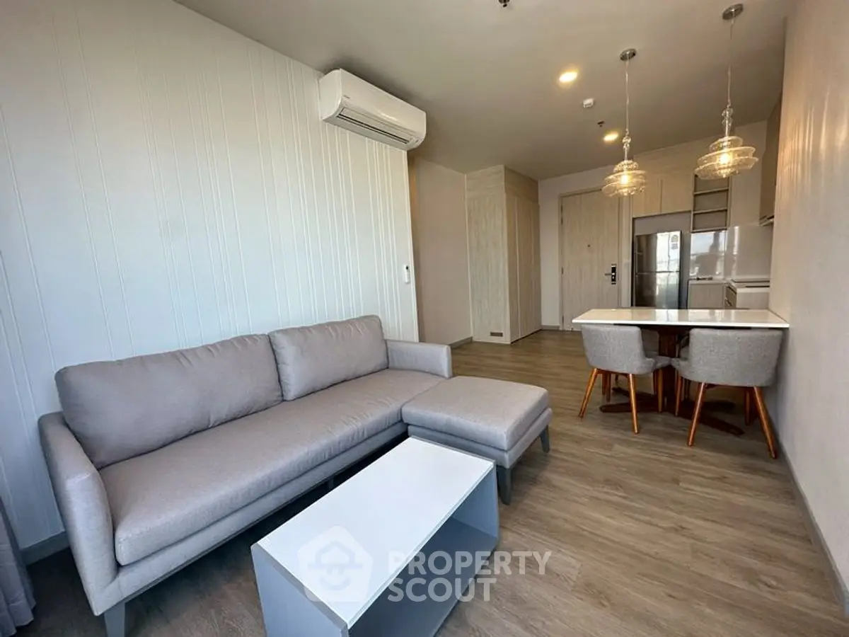 Modern living room with sleek furniture and open kitchen layout