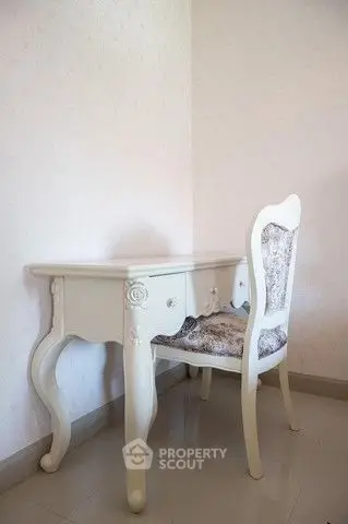 Elegant vintage-style desk and chair in a cozy corner, perfect for a home office or study nook.