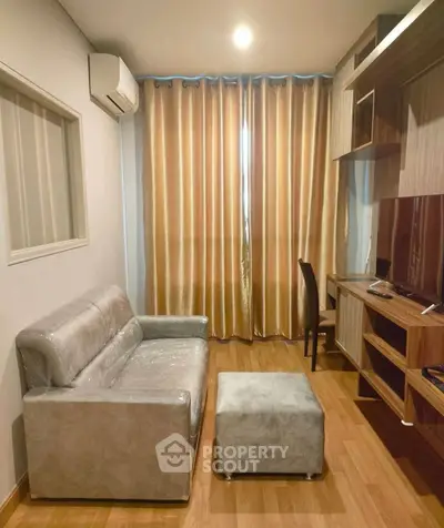 Cozy living room with modern sofa and wooden furniture, perfect for relaxation and entertainment.