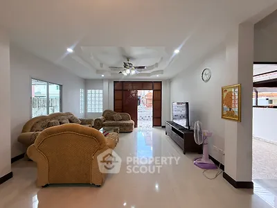 Spacious living room with elegant furniture and modern ceiling fan