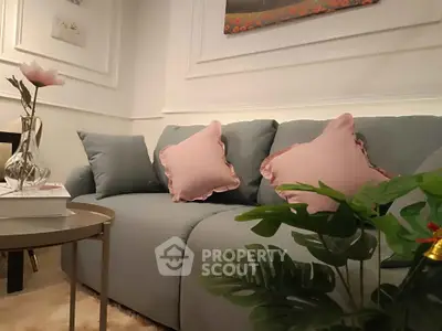 Chic living room with elegant sofa and stylish decor, perfect for modern urban living.