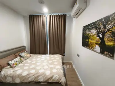 Cozy bedroom with stylish decor and natural light, featuring a comfortable bed and elegant wall art.