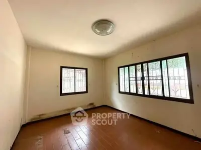 Spacious empty room with large windows and tiled flooring, ideal for customization.
