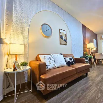 Stylish living room with modern decor and cozy brown sofa, perfect for relaxation and entertaining.