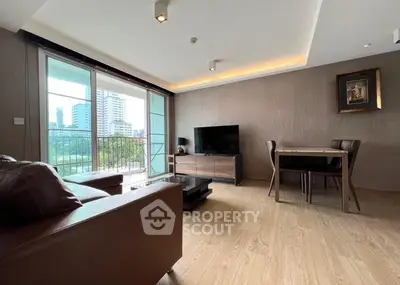 Modern living room with city view, stylish furniture, and elegant lighting.