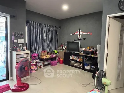 Cozy living room with modern decor and ample storage space, perfect for family gatherings.
