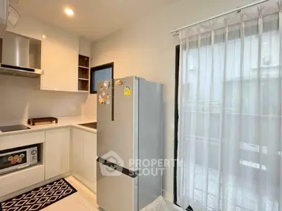Modern kitchen with sleek appliances and natural light