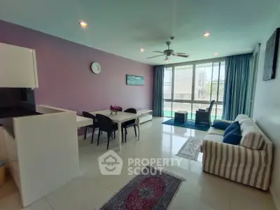 Spacious living room with modern decor and large windows for natural light.