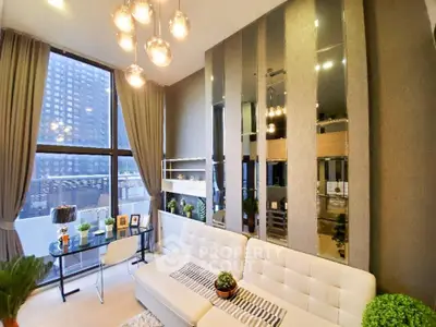Luxurious modern living room with floor-to-ceiling windows and elegant decor in a high-rise apartment.