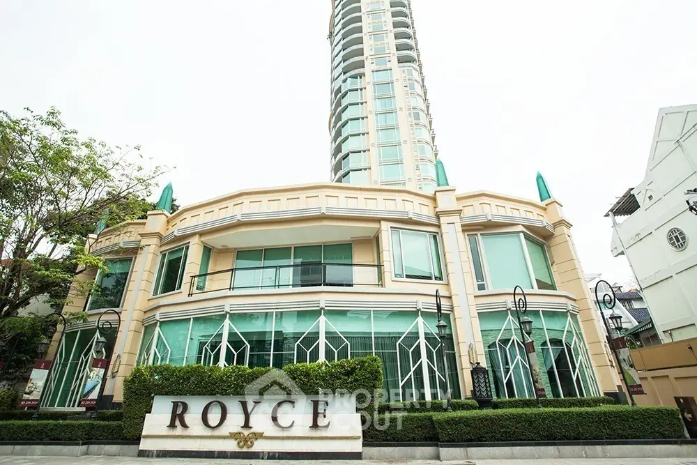 Luxurious high-rise building with modern architecture and lush greenery at Royce Residence.