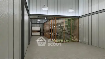 Modern industrial interior with glass-enclosed garden and sleek kitchen area.