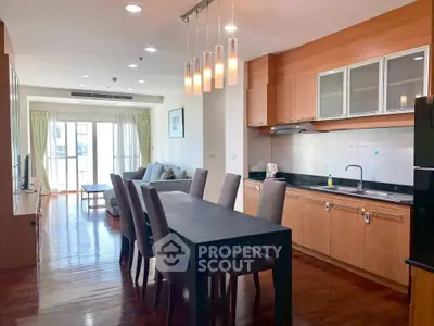 Spacious open-layout kitchen and dining area with modern furnishings and natural light.