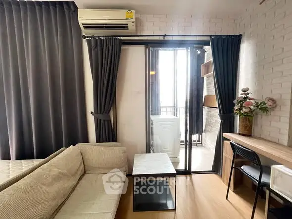 Modern living room with balcony, sofa, and study area in stylish apartment.