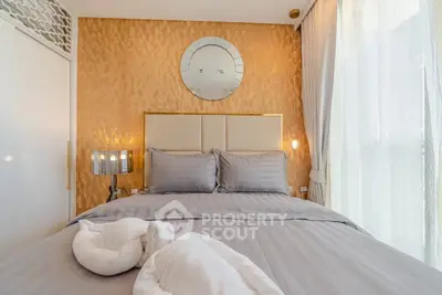 Luxurious bedroom with elegant decor and soft lighting, featuring a plush bed and stylish mirror accent.