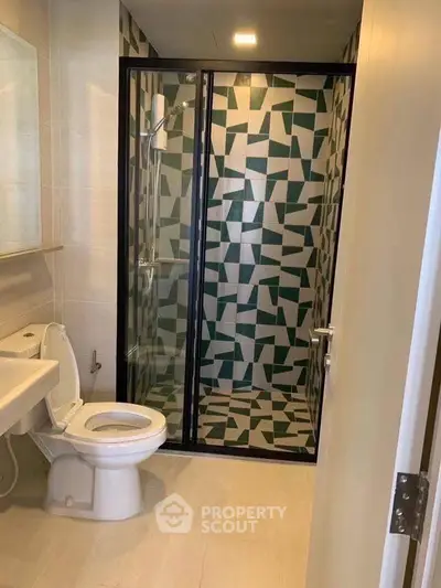 Modern bathroom with geometric tile shower and sleek fixtures