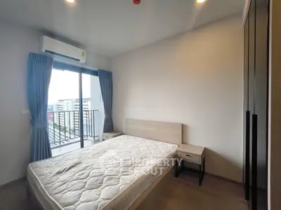 Modern bedroom with balcony access in high-rise apartment