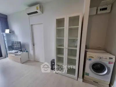 Modern living room with air conditioning and washing machine in a stylish apartment.