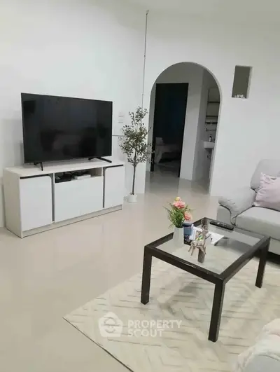 Modern living room with sleek TV stand and cozy seating area