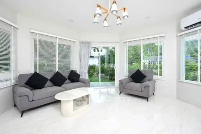 Bright and spacious living room with modern furniture and garden view.