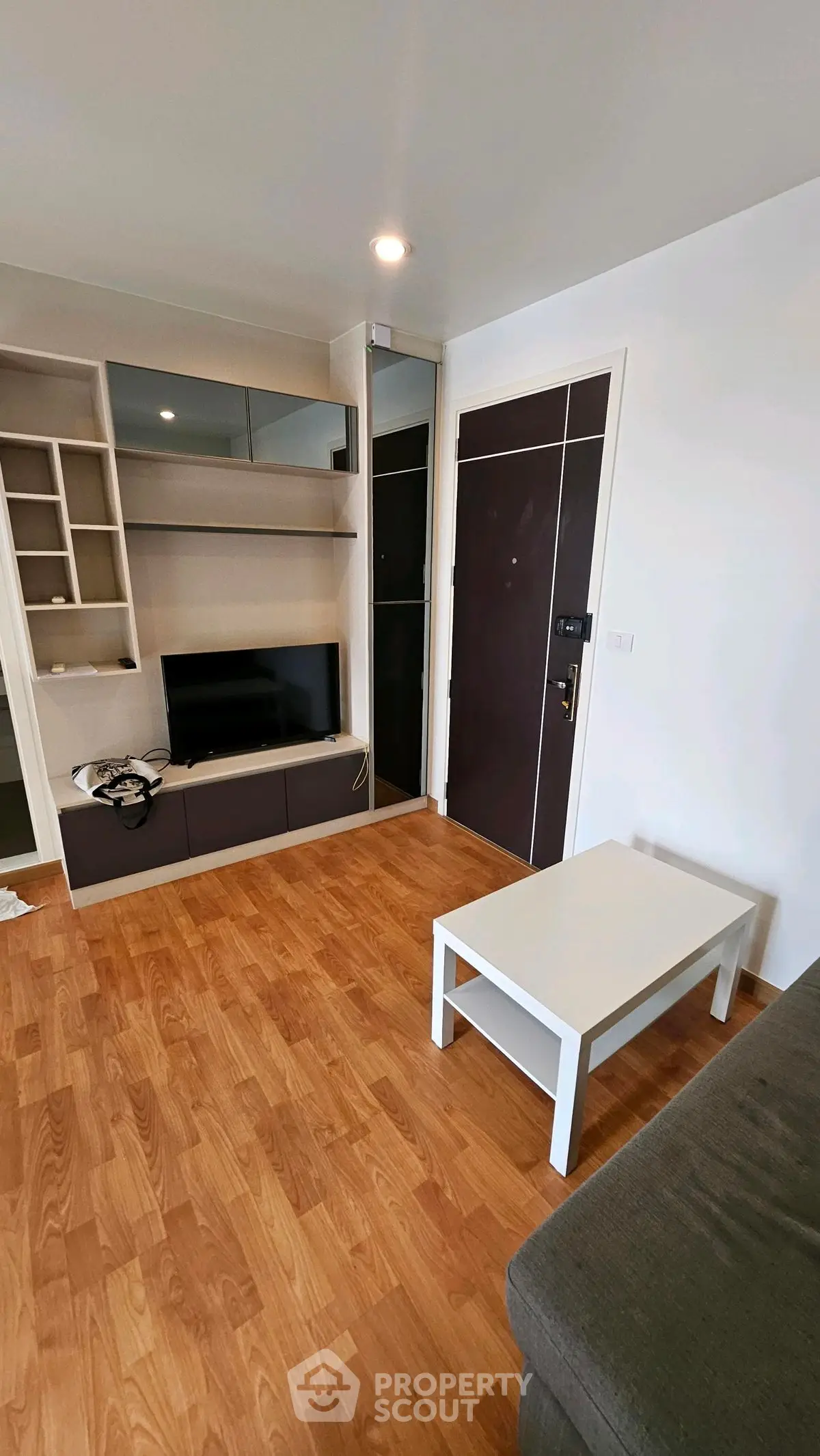 Modern living room with wooden flooring and sleek furniture design