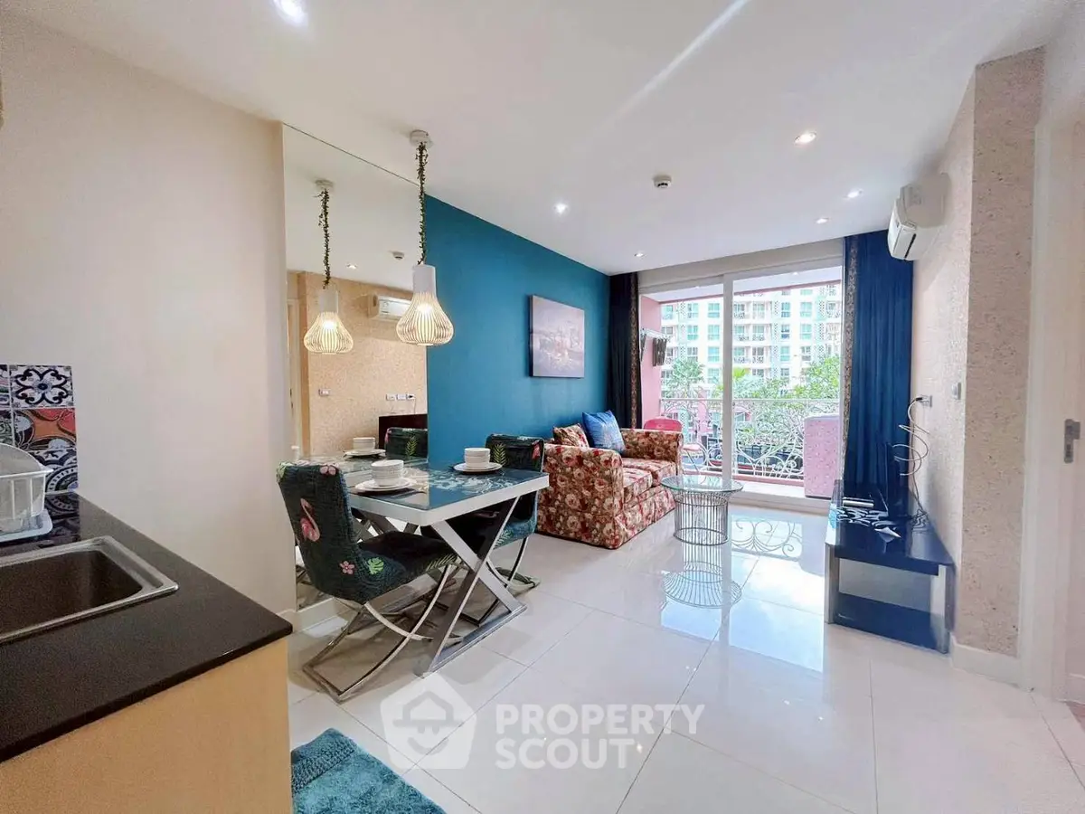 Modern living room with stylish decor and balcony view in a vibrant apartment.