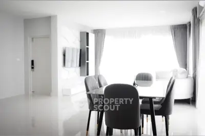 Modern dining area with sleek furniture and natural light in a stylish apartment.