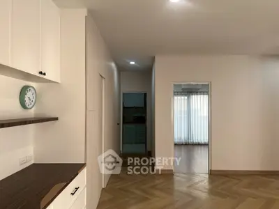 Spacious modern apartment interior with elegant wood flooring and natural light
