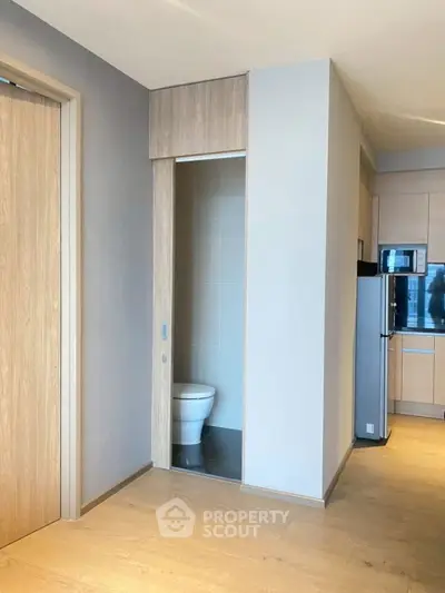 Modern apartment interior with wooden flooring and compact bathroom