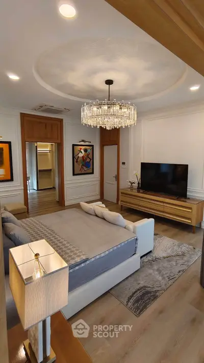 Luxurious bedroom with elegant chandelier and modern decor