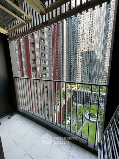 Stunning balcony view of modern high-rise buildings and lush green courtyard.