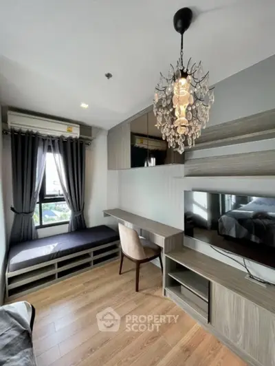 Modern study room with elegant chandelier and built-in desk in a stylish apartment.