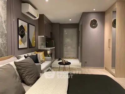 Modern studio apartment with stylish decor and compact kitchen area