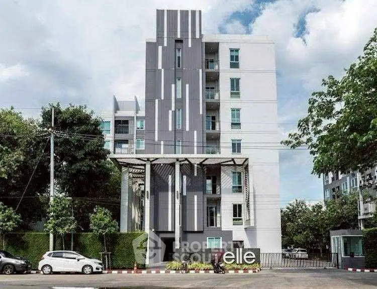 Modern apartment building exterior with sleek design and lush greenery, perfect for urban living.