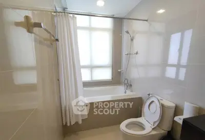 Modern bathroom with bathtub and shower in sleek design