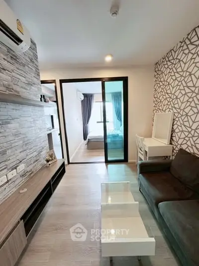Modern living room with stylish decor and open view to bedroom