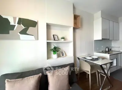 Modern compact living room with integrated kitchen and stylish decor.