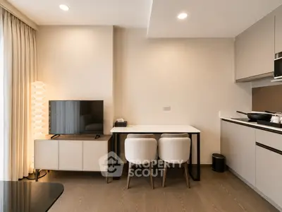 Modern living room with sleek furniture and open kitchen layout, perfect for contemporary urban living.