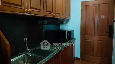 Cozy kitchen with wooden cabinets and modern appliances