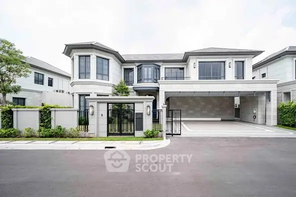 Luxurious modern two-story house with spacious driveway and elegant facade in a serene neighborhood.