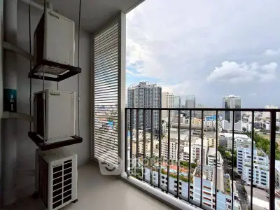 High-rise balcony with cityscape view and air conditioning units.