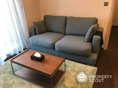 Cozy living room with plush sofa and stylish coffee table on soft rug