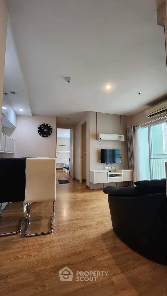 Modern living room with wooden flooring and stylish furniture in a cozy apartment