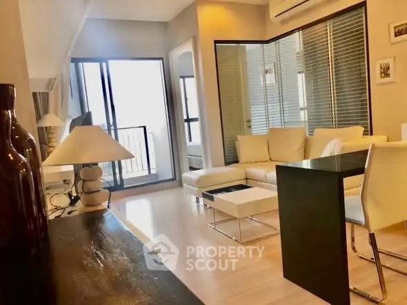 Modern living room with sleek furniture and balcony access