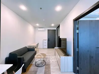 Modern living room with sleek furniture and stylish decor in a contemporary apartment.