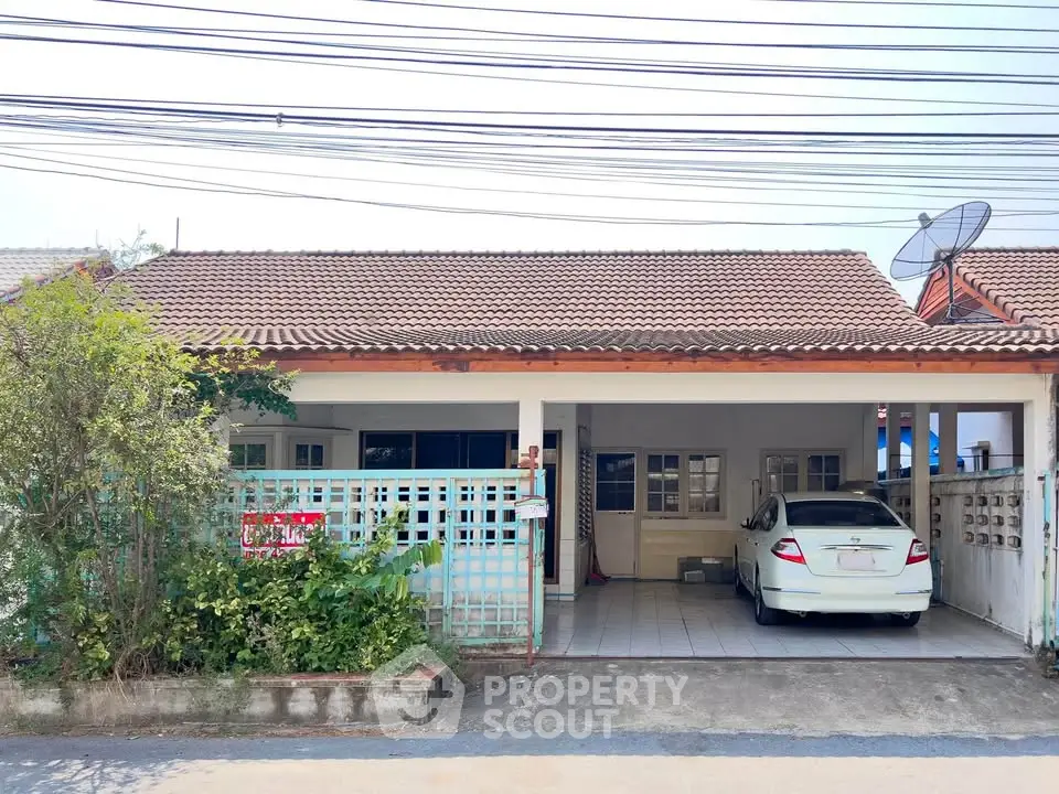 Charming single-story home with carport and satellite dish in a quiet neighborhood.