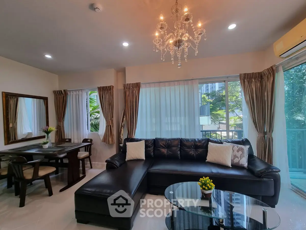 Luxurious living room with elegant chandelier and spacious seating area, perfect for relaxation and entertaining.