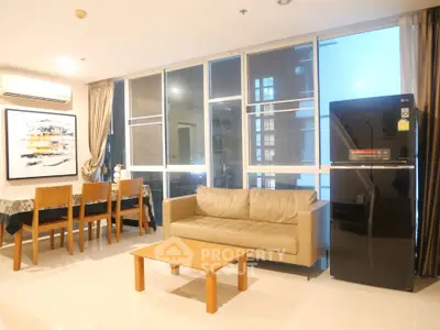 Spacious living room with modern furniture and large windows in a stylish apartment.